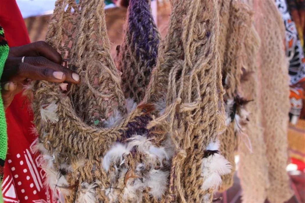 Fibre bilum with chicken feathers woven in