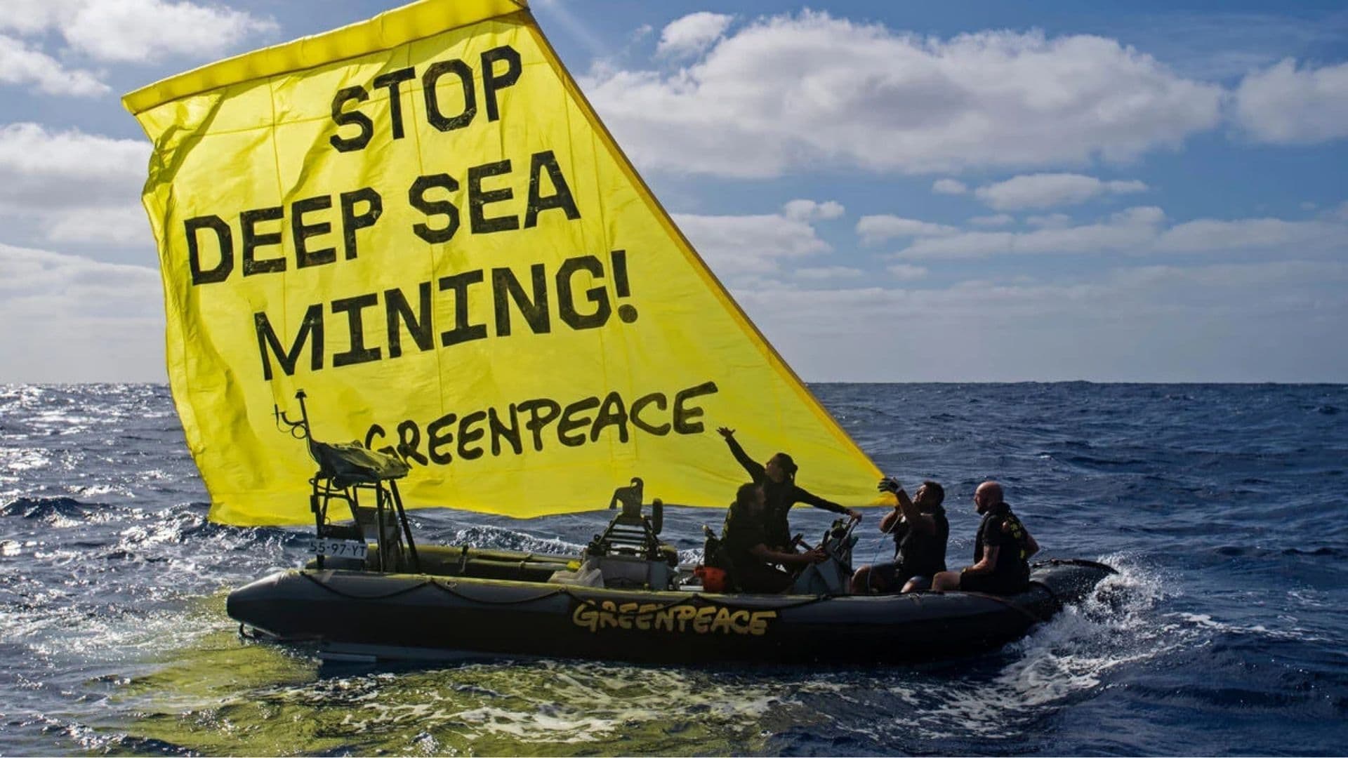Indigenous canoe displays a banner calling for a stop to deep sea mining